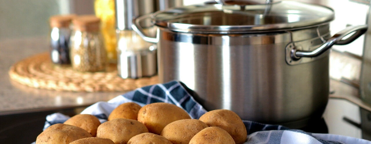 Potatoes next to a saucepan